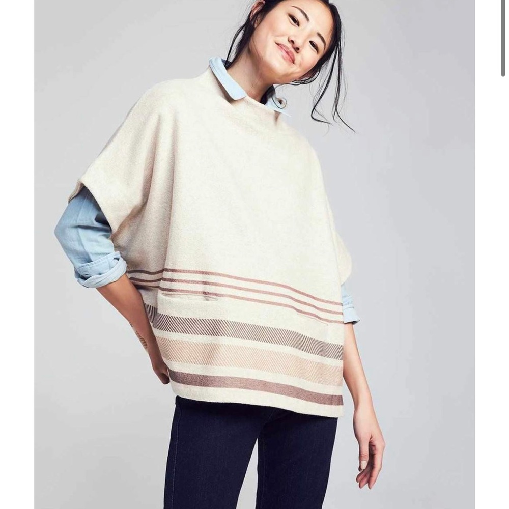 Oversized fit. High neck poncho, shape. 73% Polyester, 27% Wool. Hand wash cold.